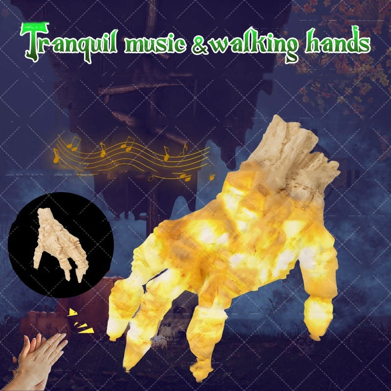 Light-up hand-shaped object with glowing yellow lights on a dark background with music notes.