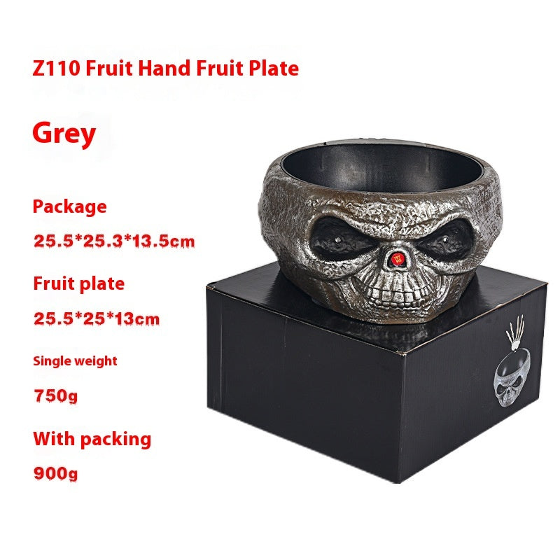 Skull-shaped fruit plate on a black box with product details in red text.