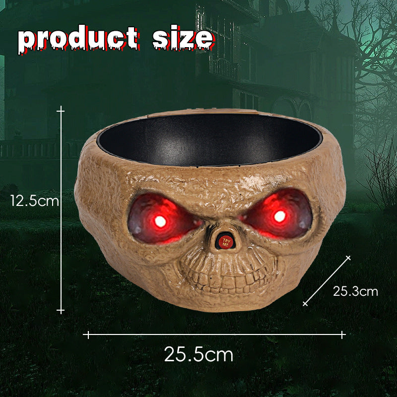 Skull-shaped bowl with glowing red eyes on a dark background, showing product size measurements.