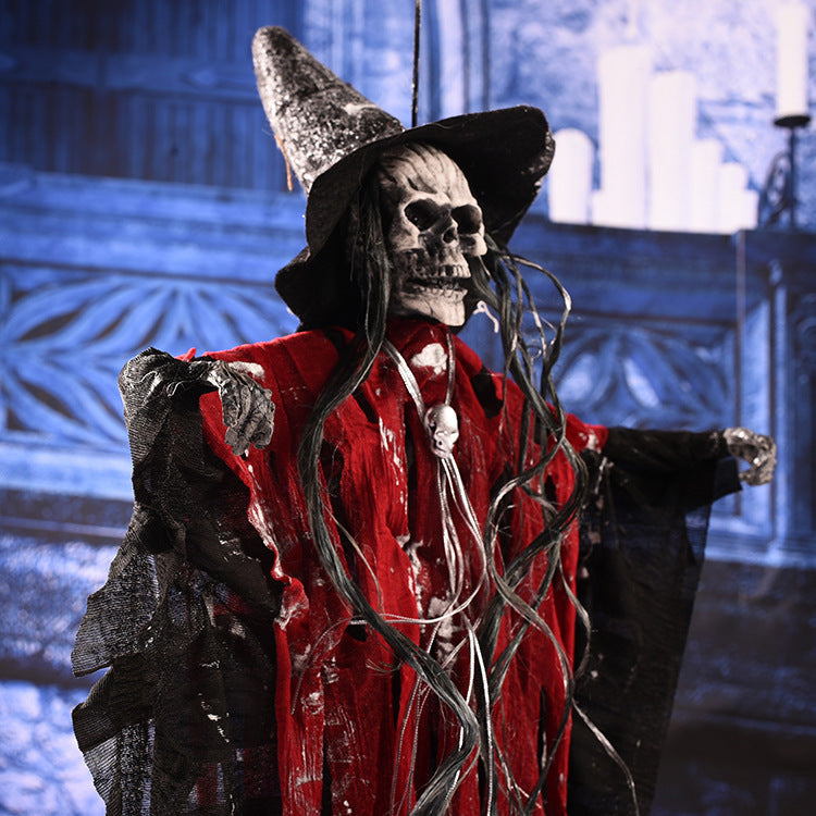 Halloween decoration with a skeleton in a witch costume against a dark background.