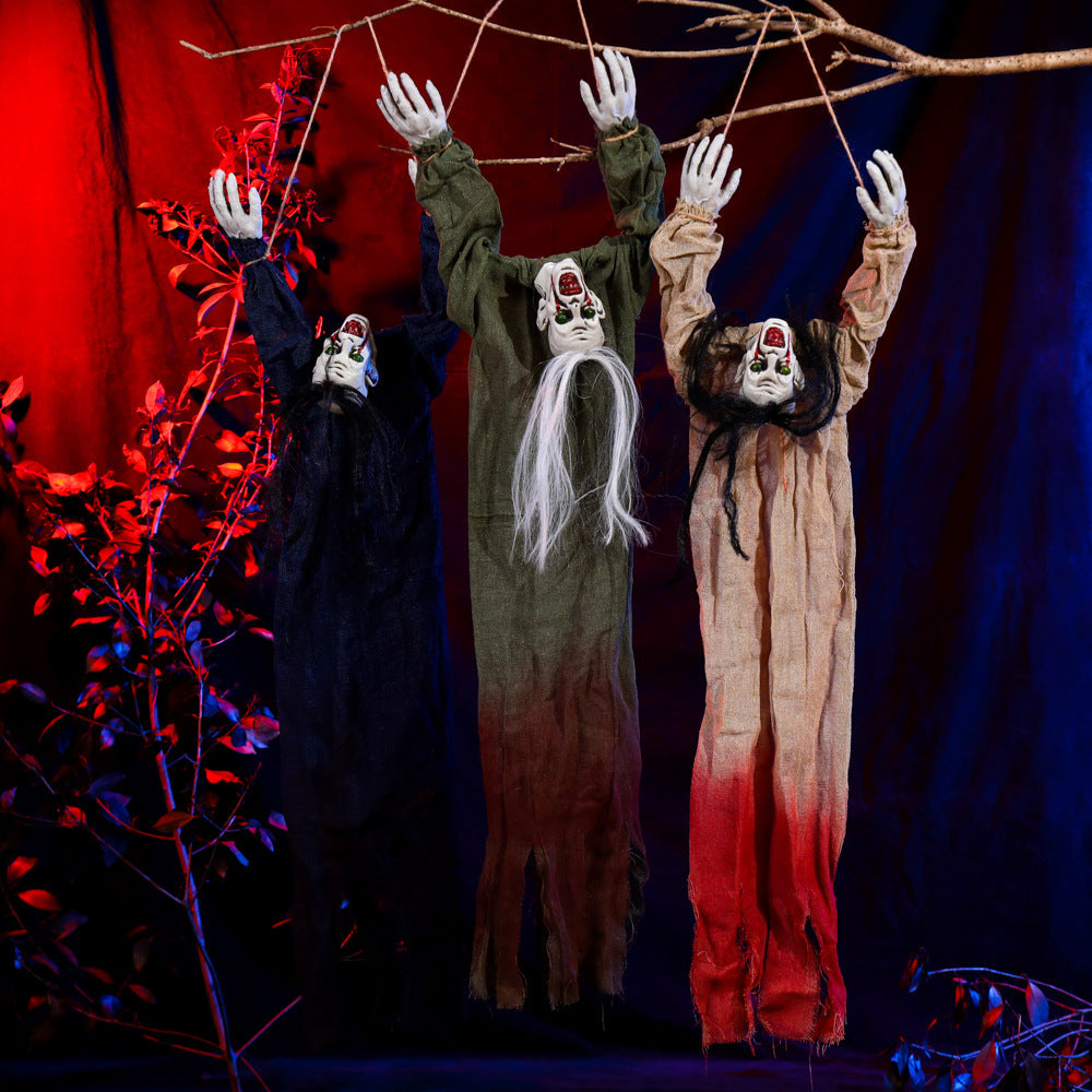 Three ghostly figures hanging from a branch against a red and blue background
