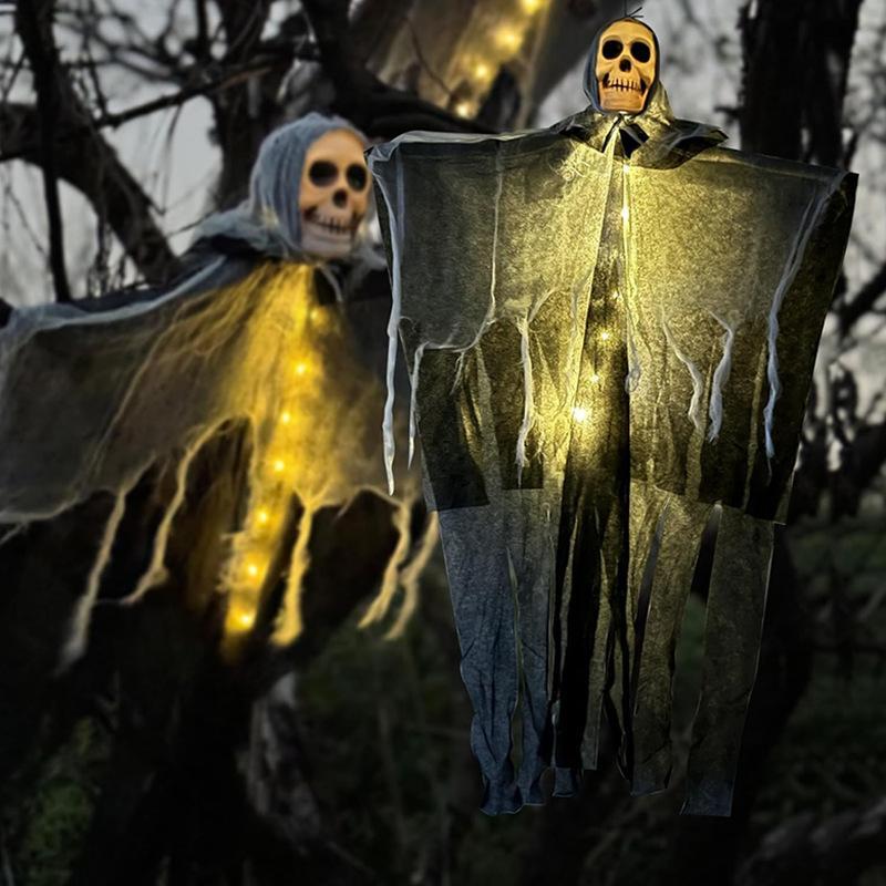 Two ghostly figures with illuminated yellow lights against a dark background