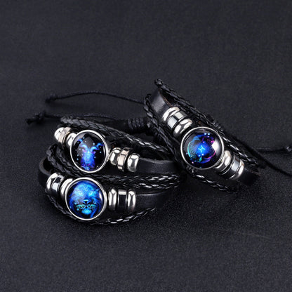 Black braided leather bracelets with blue gemstones on a dark background