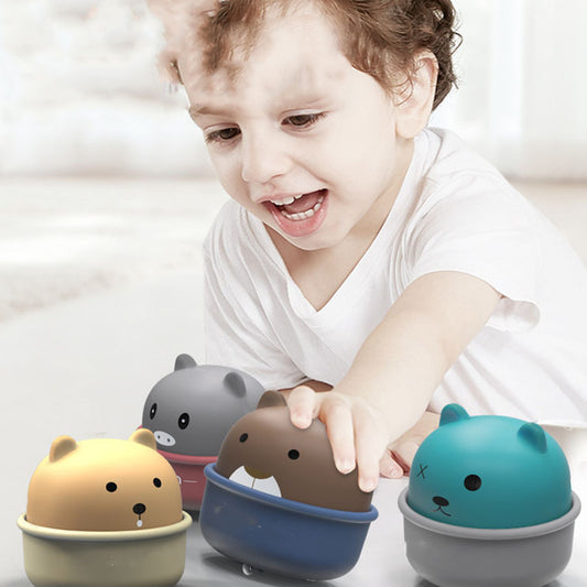 Child playing with four animal-shaped containers on a light background