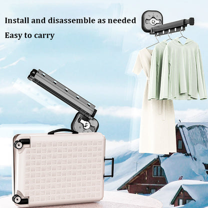 Portable clothesline with a suitcase on a snowy background