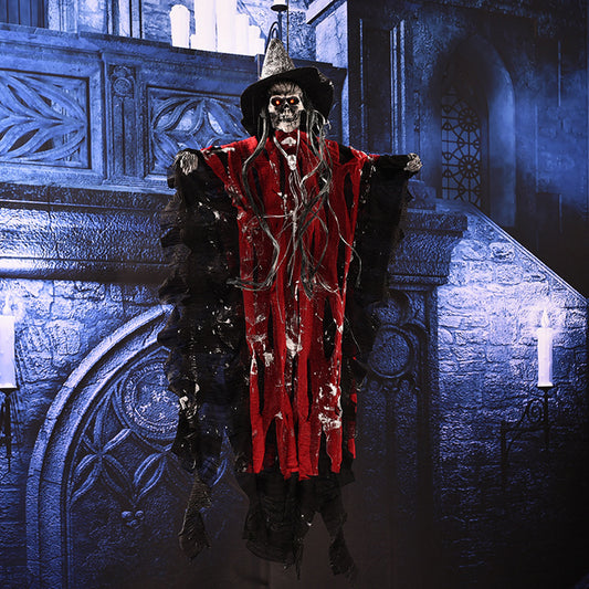 Skeleton in a red robe and black hat standing in a dimly lit room with stone walls.