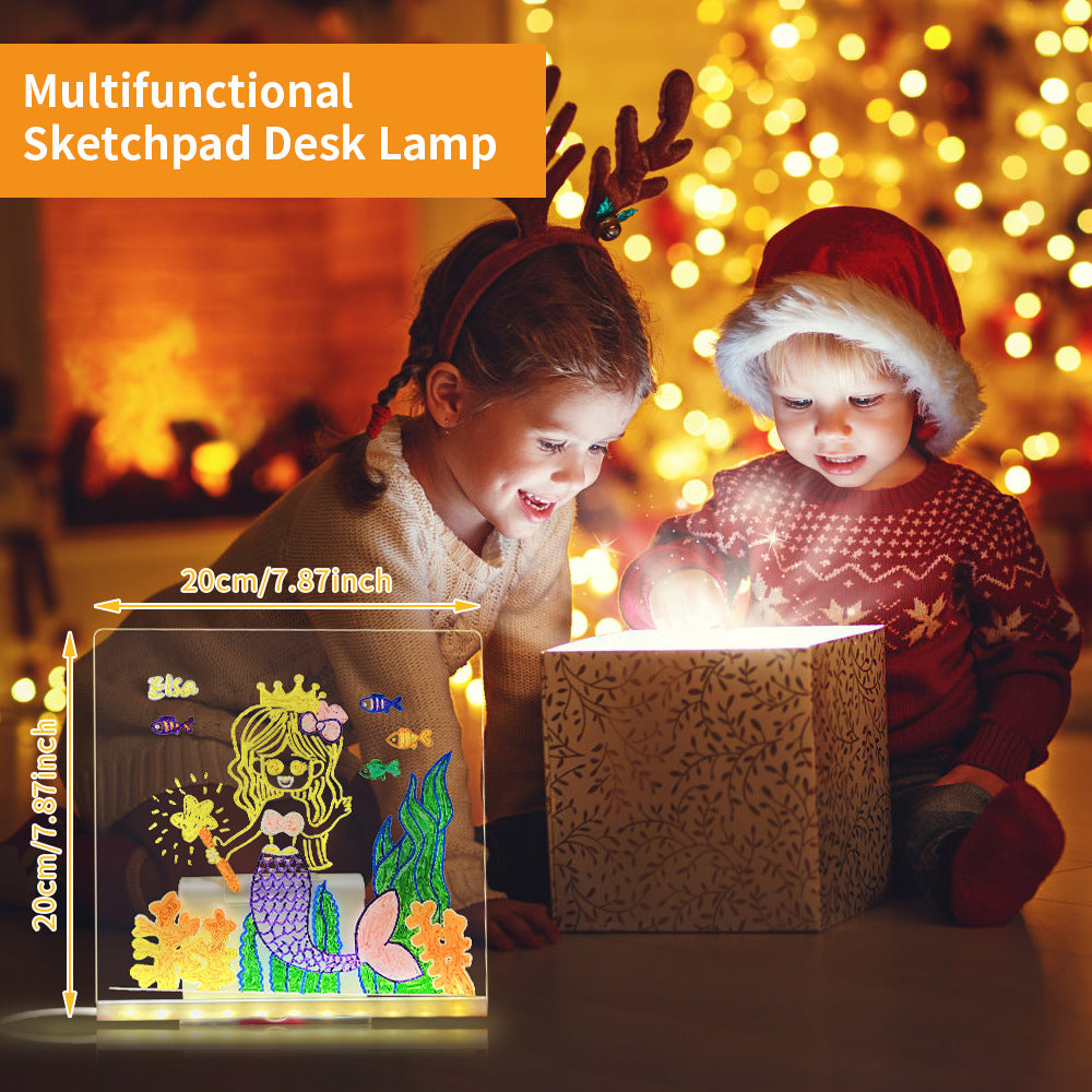 Two children playing with a multifunctional sketchpad desk lamp in a warm, festive setting.