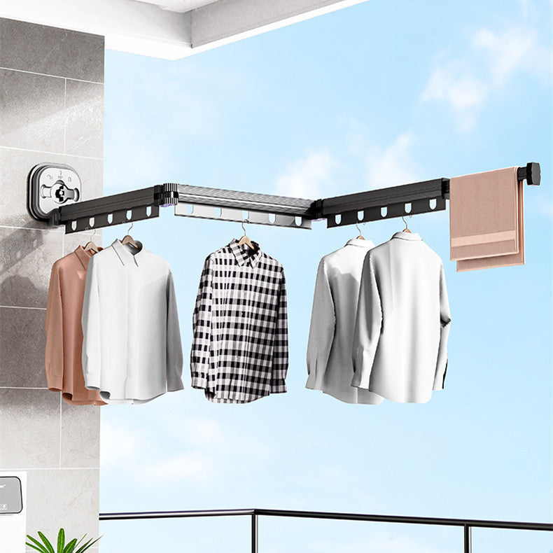 Corner clothes rack with hanging clothes against a blue sky background