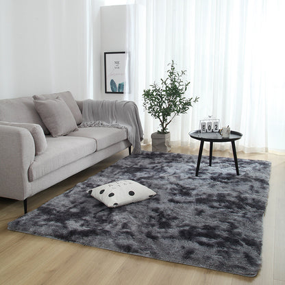 Living room with a gray rug, sofa, and small table.