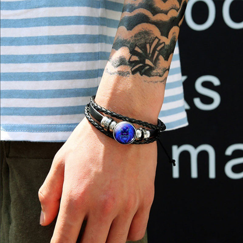 Person wearing a bracelet with a blue stone on a blurred background