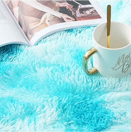 Turquoise fluffy blanket with a mug and magazine on top