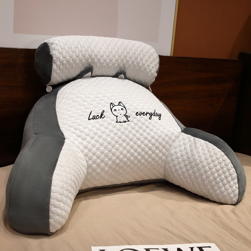 Gray and white pillow with 'Luck everyday' text on a bed