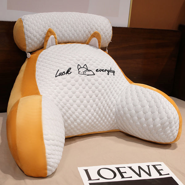Fox-shaped pillow with 'Luck everyday' text on a surface with a LOEWE brand card.