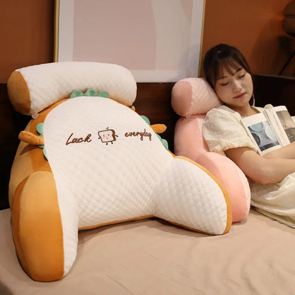 Woman lying on a large, plush, dinosaur-shaped pillow with 'Luck everyday' text.