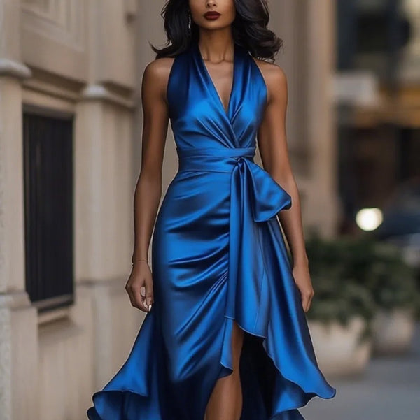 Woman wearing a blue dress standing in an urban setting