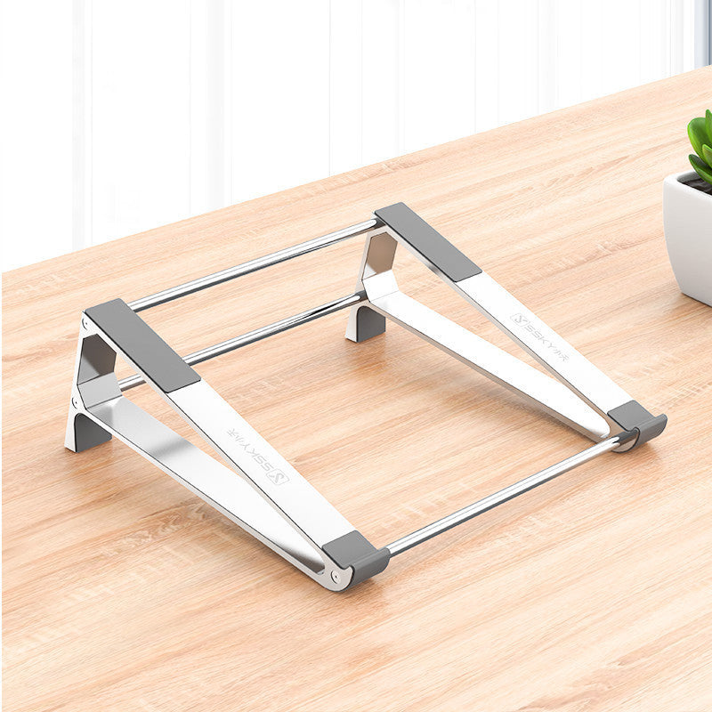 Metallic laptop stand on a wooden surface with a blurred background