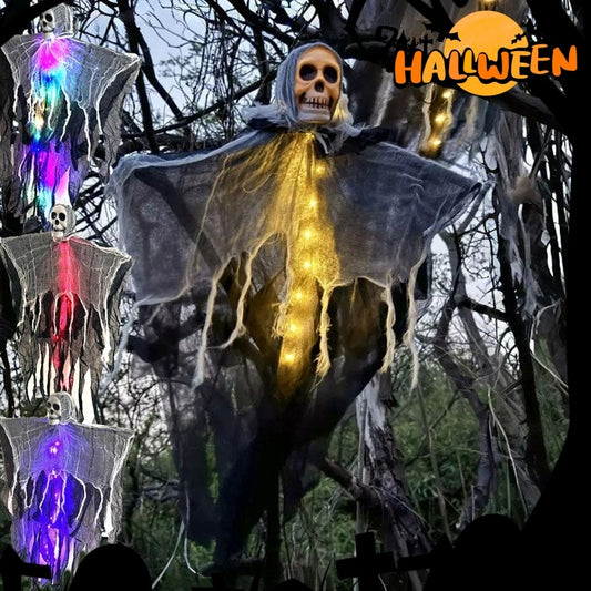 Halloween-themed decoration with a illuminated ghost figure in a forest setting.