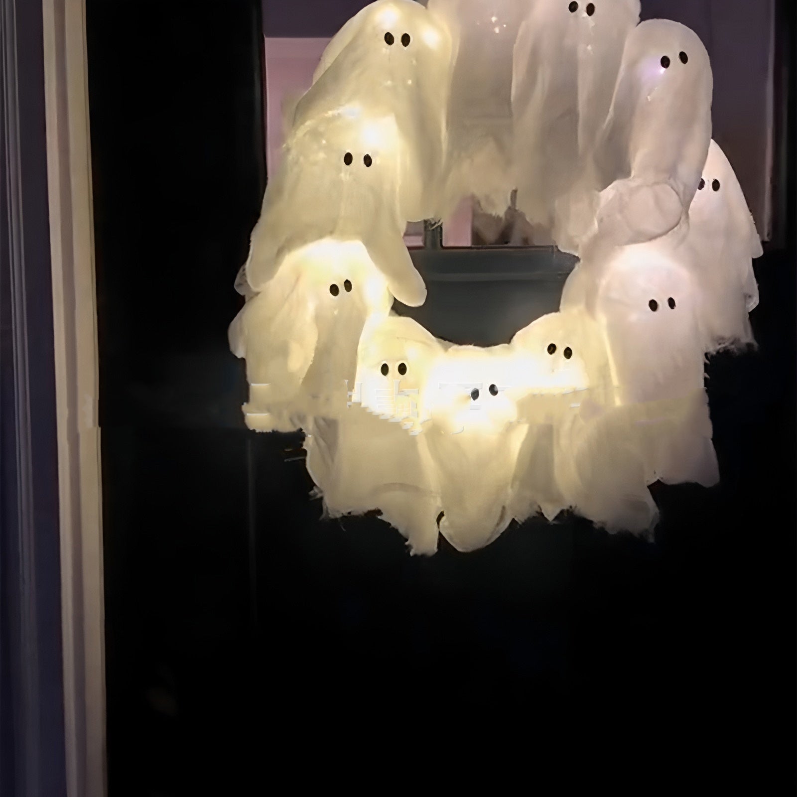 Decorative wreath with ghost lights on a dark background