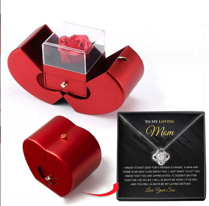 Red gift box with a rose and a card for mom on a white background