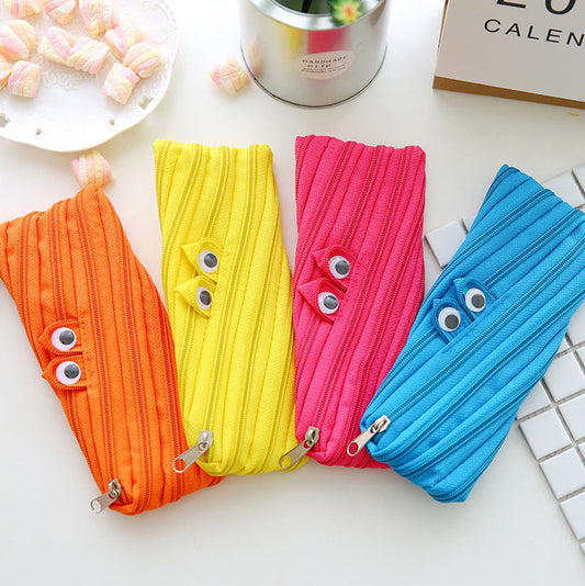 Four colorful pouches with googly eyes on a white surface