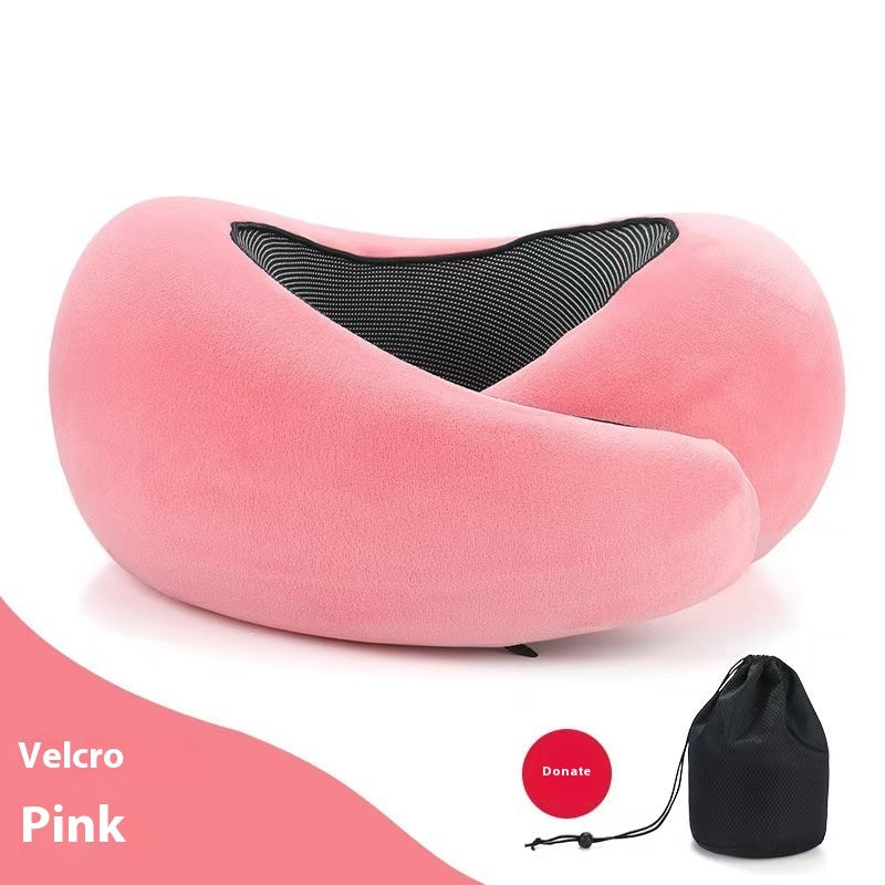 Pink neck pillow with black interior on a white background, including a black carrying bag.