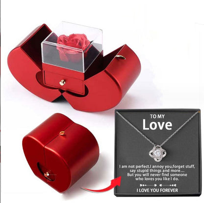 Red jewelry box with a rose and a necklace with a message card on a white background